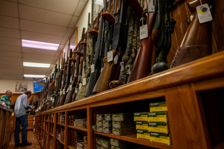AUSTIN, TEXAS - AUGUST 25: Customers shop for firearmsin the McBride Guns Inc. store on August 25, 2023 in Austin, Texas. The Biden administration plans to revoke licenses from hundreds of firearms dealers, provoking disagreements among gun-store owners and law-enforcement veterans around the country.